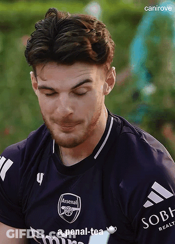 Man In Purple Arsenal Jersey Looking Down GIF