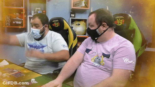 Man In Purple Cat Shirt Next To Masked Man GIF