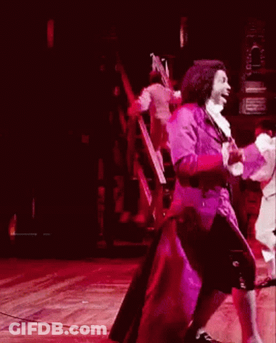 Man In Purple Coat Dancing On Stage GIF