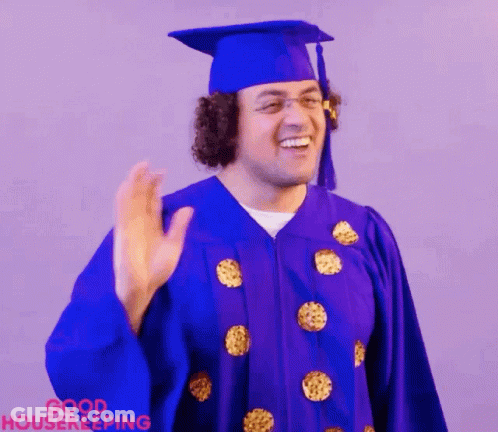 Man In Purple Graduation Cap And Gown Waving GIF