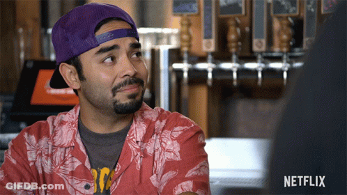 Man In Purple Hat And Red Shirt With Netflix Logo GIF