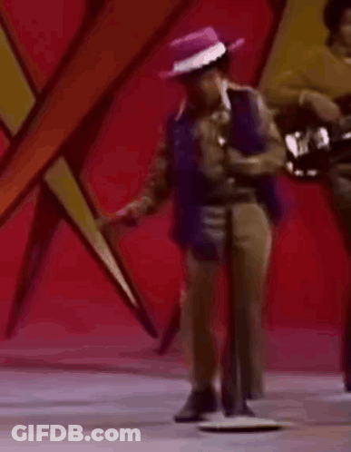 Man In Purple Hat Dancing At Microphone GIF