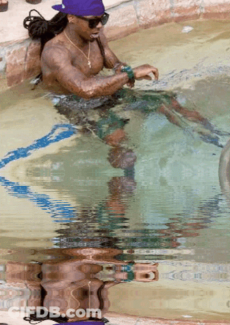 Man In Purple Hat Sitting In Swimming Pool GIF