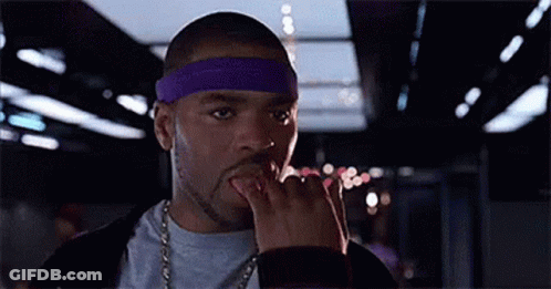 Man In Purple Headband And Chain Licking Fingers GIF