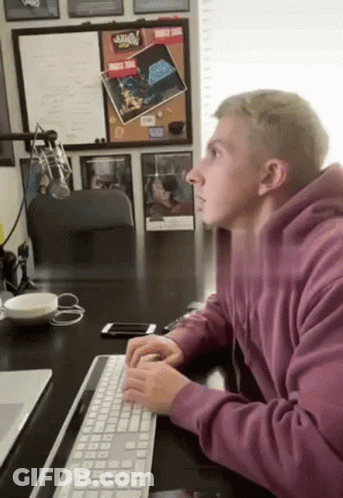 Man In Purple Hoodie Typing GIF