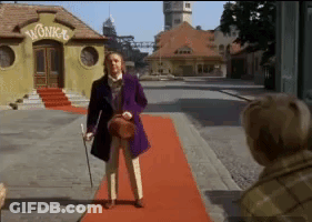 Man In Purple Jacket And Top Hat Holding Jar GIF