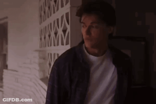 Man In Purple Jacket And White Shirt In Dark Room GIF