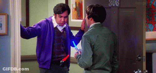 Man In Purple Jacket Holding Light Saber GIF