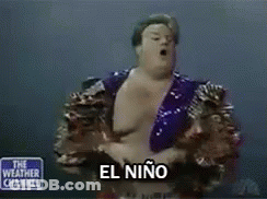 Man In Purple Jacket In Front Of The Weather Channel Sign GIF