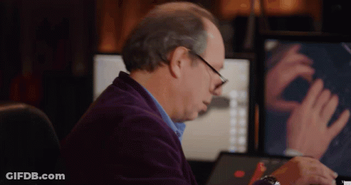 Man In Purple Jacket Sitting At Computer GIF