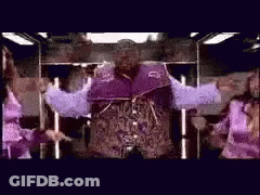 Man In Purple Jacket Standing With Arms Out GIF