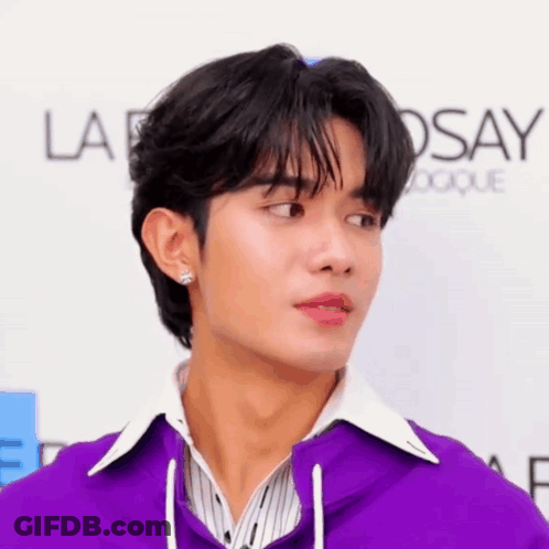 Man In Purple Jacket White Shirt At La Roche Posay Sign GIF