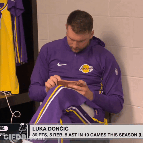 Man In Purple Lakers Jacket In Locker Room GIF