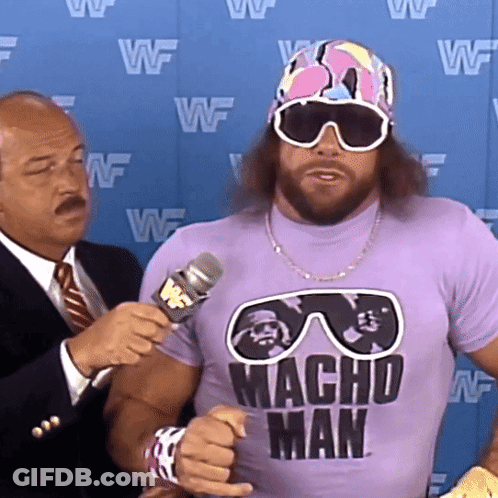 Man In Purple Macho Shirt Being Interviewed GIF