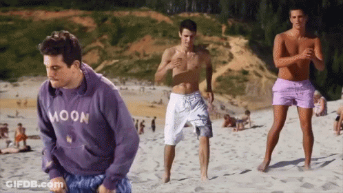 Man In Purple Moon Sweatshirt On Sandy Beach GIF