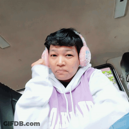 Man In Purple Oakland Sweatshirt And Ear Muffs GIF