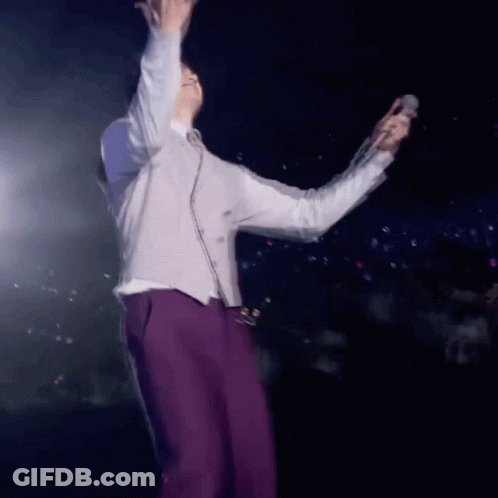 Man In Purple Pants Holding Microphone GIF