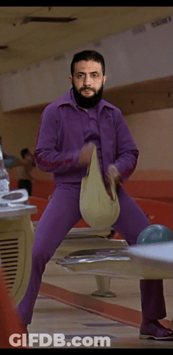 Man In Purple Pants Standing On Bowling Ball GIF