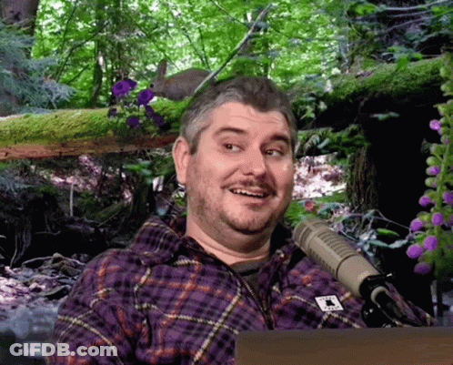 Man In Purple Plaid Shirt With Letter T GIF