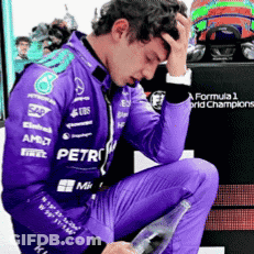Man In Purple Racing Suit Kneeling Holding Water GIF