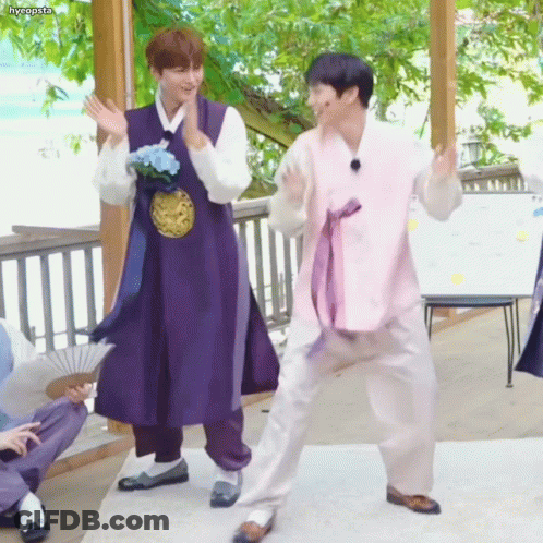 Man In Purple Robe Next To Man In Pink Robe GIF