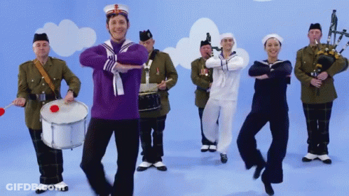 Man In Purple Sailor Uniform Dancing With Band GIF
