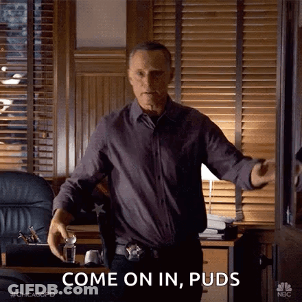 Man In Purple Shirt And Black Pants Talking In Office GIF