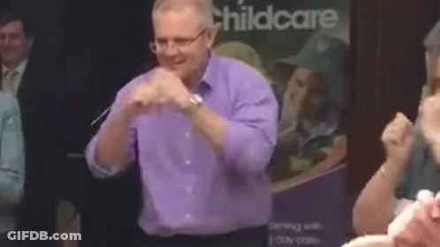 Man In Purple Shirt And Glasses Dancing At Childcare Sign GIF
