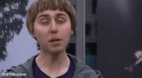 Man In Purple Shirt And Gray Jacket Making Funny Face GIF