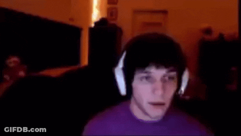 Man In Purple Shirt And Headphones At Computer GIF