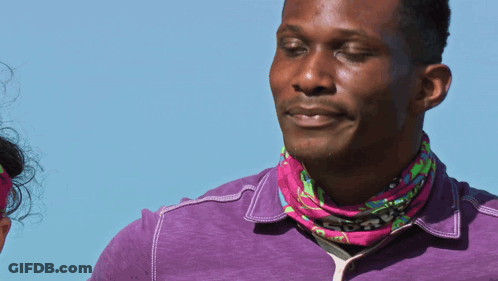 Man In Purple Shirt And Pink Bandana Looking To Side GIF