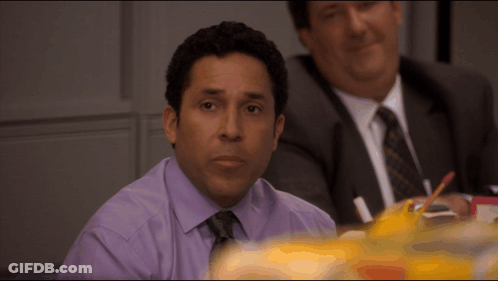 Man In Purple Shirt And Tie At Table GIF