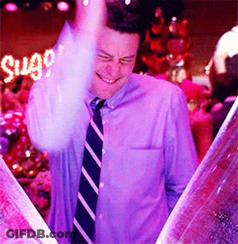 Man In Purple Shirt And Tie Smiling At Sugar Sign GIF