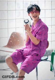 Man In Purple Shirt Blowing Bubbles GIF