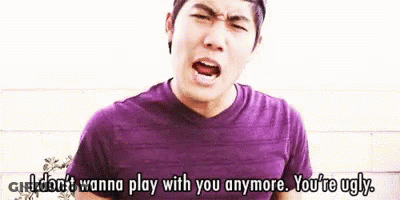 Man In Purple Shirt Blue Shorts Brick Wall GIF