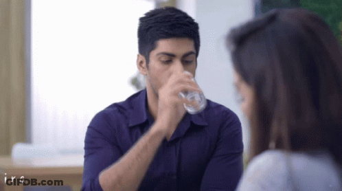 Man In Purple Shirt Drinking From Glass GIF