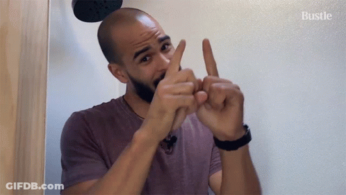 Man In Purple Shirt Gesturing Says Bustle GIF