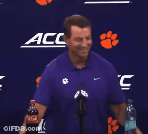 Man In Purple Shirt Holding Coca-Cola GIF