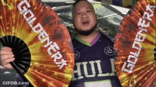 Man In Purple Shirt Holding Goldenera Fan GIF