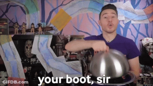 Man In Purple Shirt Holding Silver Bowl Saying Your Boot Sir GIF