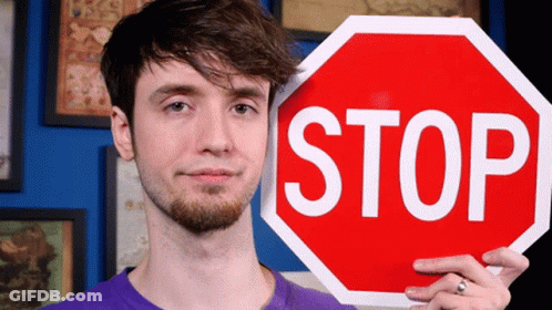 Man In Purple Shirt Holding Stop Sign GIF
