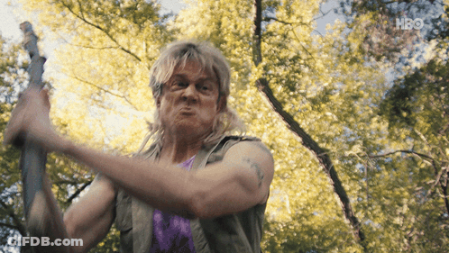 Man In Purple Shirt Holding Sword With HBO Logo GIF