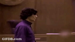 Man In Purple Shirt In Dark Room GIF
