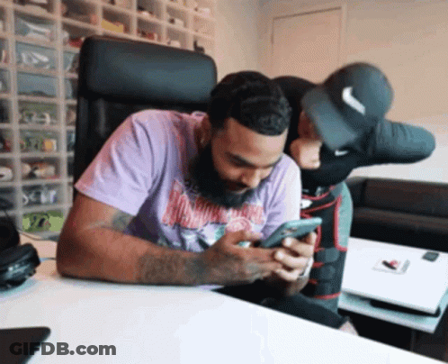 Man In Purple Shirt Looking At Cellphone GIF