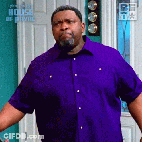 Man In Purple Shirt Making Face In Front Of Door GIF