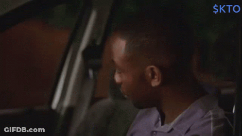 Man In Purple Shirt Sitting In Back Seat With Word Skto GIF