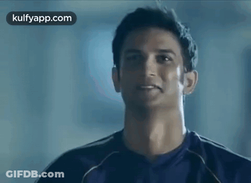 Man In Purple Shirt Smiling At Camera GIF