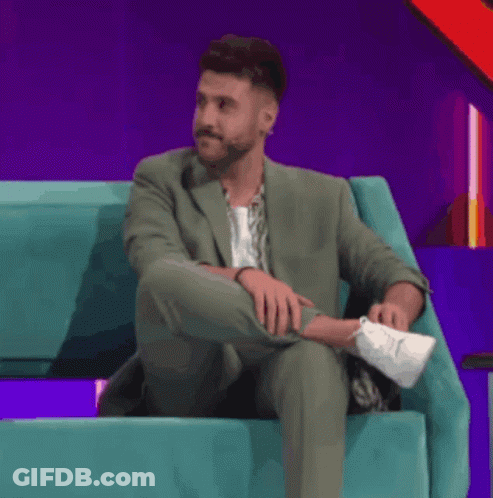 Man In Purple Shirt Smiling At Sugar Sign GIF
