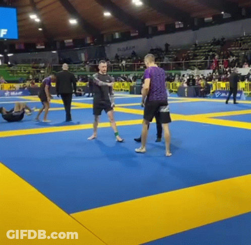 Man In Purple Shirt Standing On Boxing Ring Mat GIF