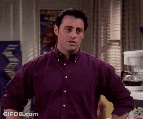 Man In Purple Shirt Standing With Hands On Hips In Kitchen GIF